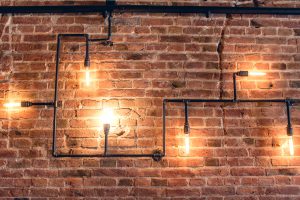 Rustic design, brick wall with light bulbs and pipes